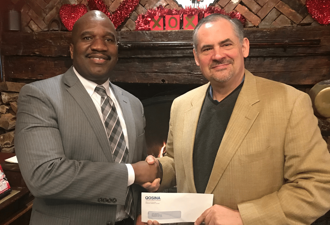 Ken Wolcott, director of marketing and product development for Qosina, recently made a $5,000 donation, accepted by Stanfort J. Perry, executive director of AHRC Nassau.