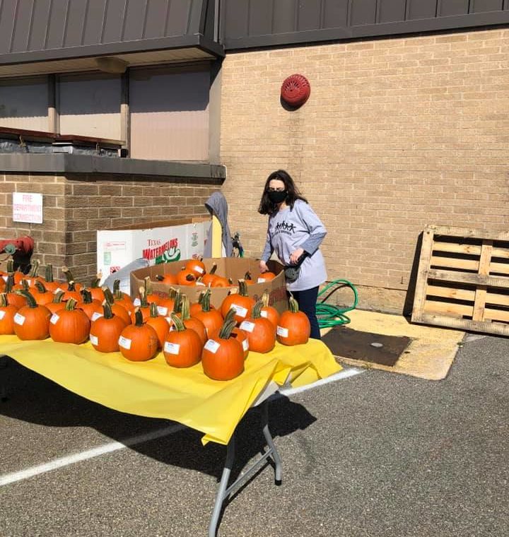 Volunteer Helps With Table at Staff Appreciation Day