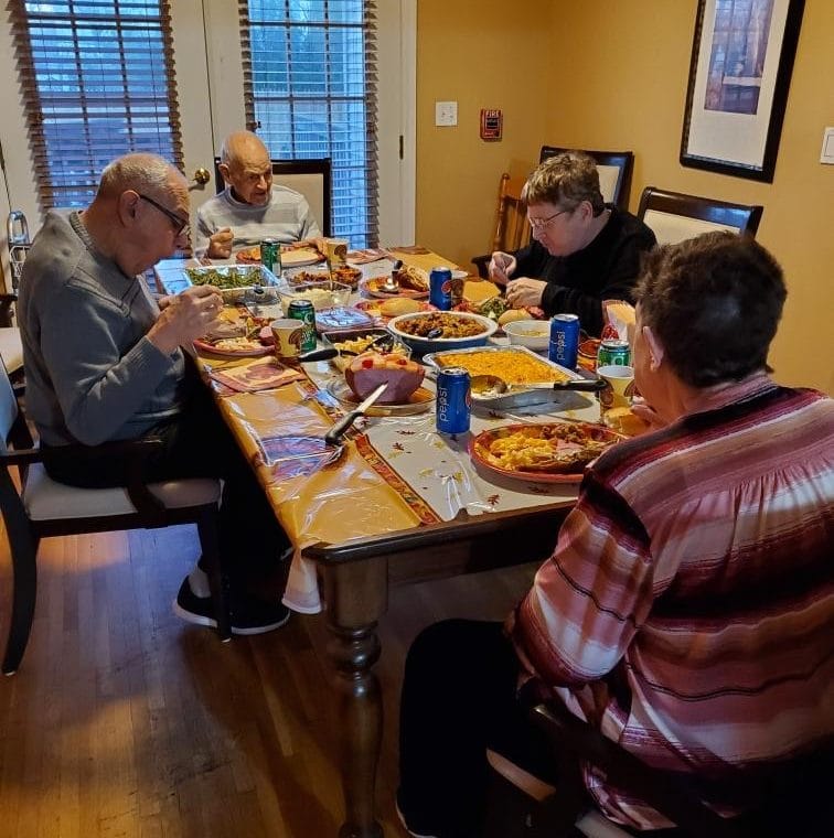 People supported by AHRC sit down to Thanksgiving dinner