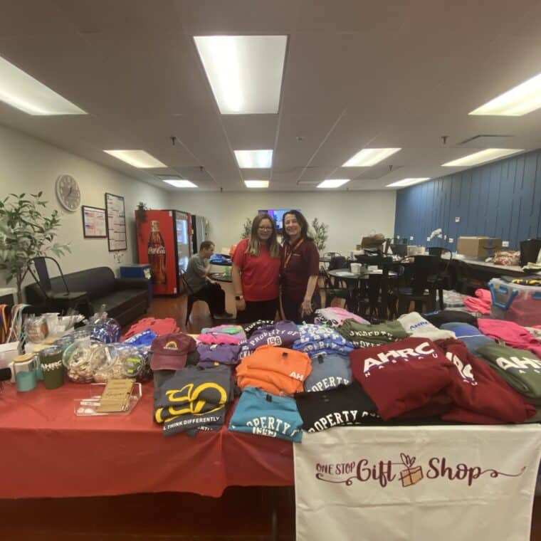 Employees pose with merchandise at One Stop Gift Shop