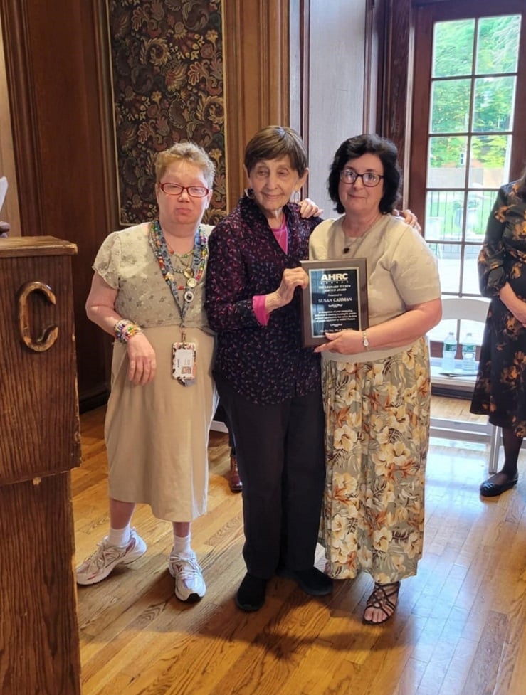 AHRC Nassau volunteers pose with their award