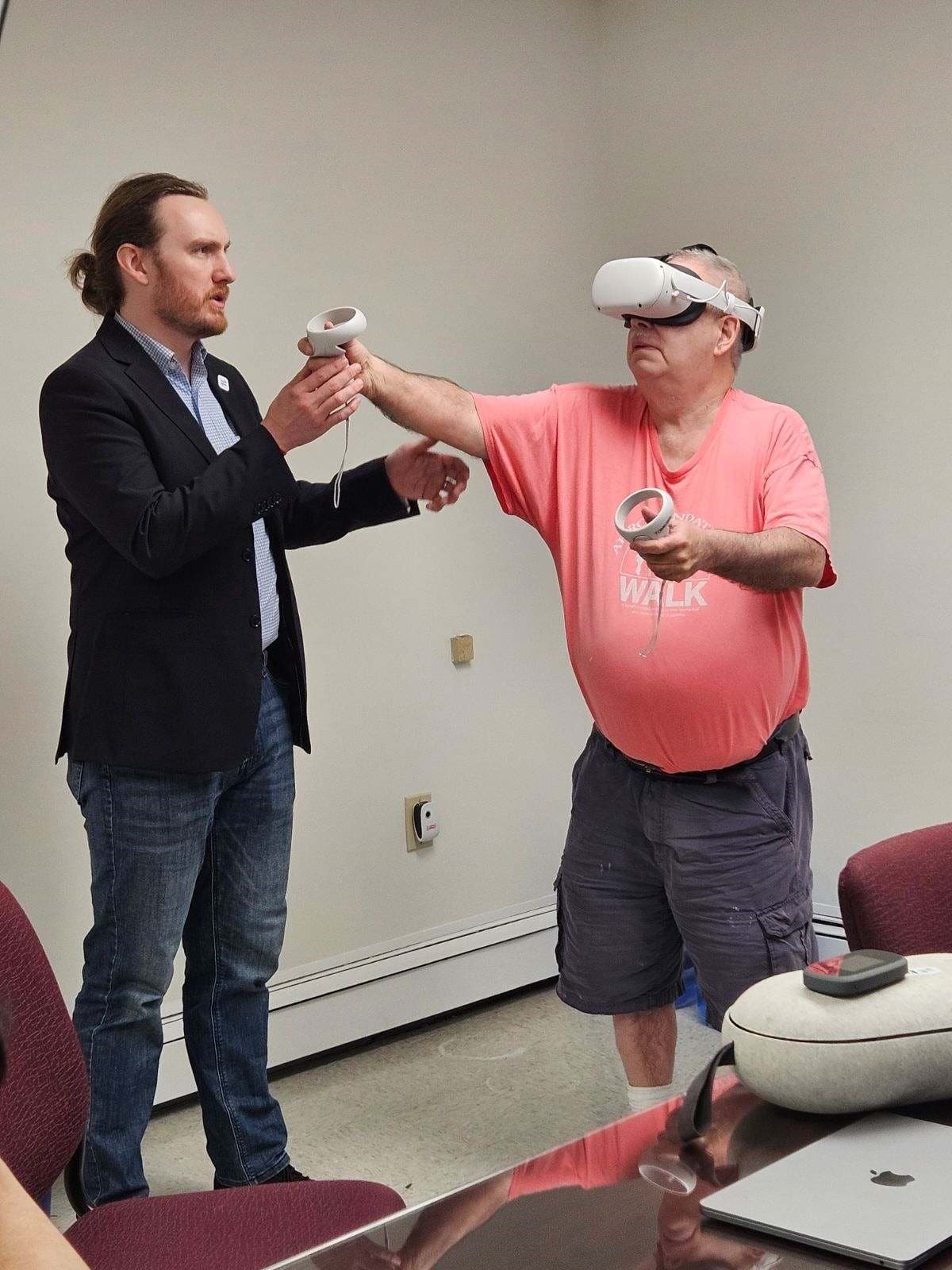 A person supported uses the ACCES-VR system with guidance