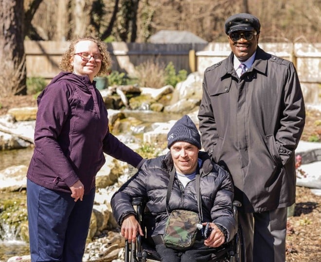 AHRC Nassau CEO Stanfort Perry and people supported by AHRC Nassau in the new Wheatley Farms and Arts Center Meditation Garden.